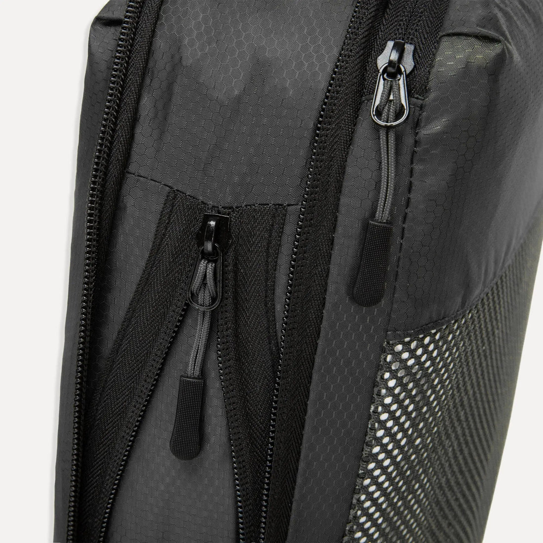 Close up of the Cube Packer Black Packing Cube showing the compression and main ziip