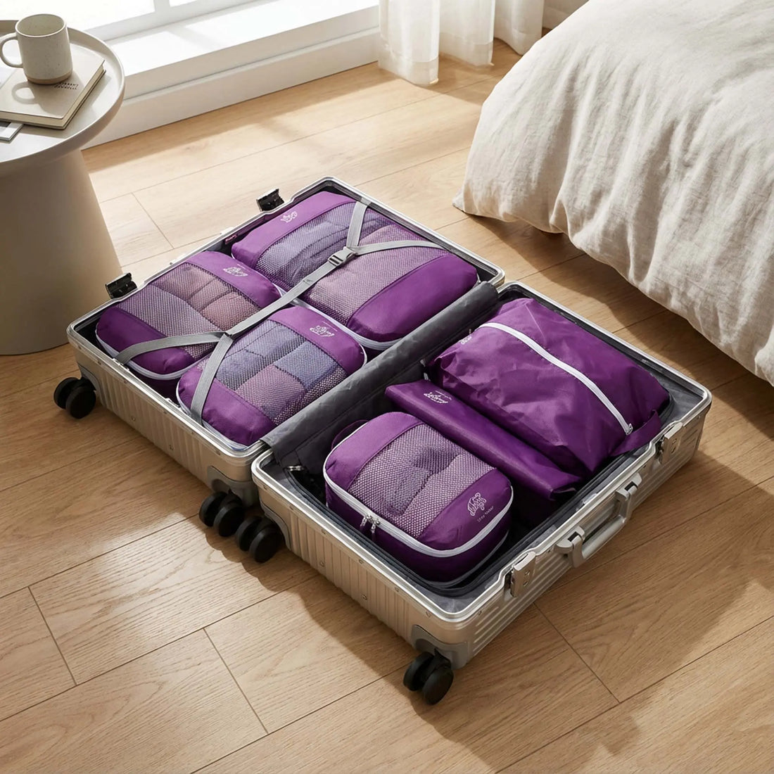 Open suitcase neatly packed using packing cubes to organise clothing efficiently
