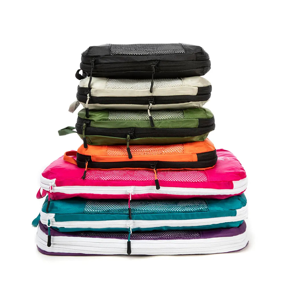 All the colours of the Cube Packer Packing Cubes stacked on top of each other