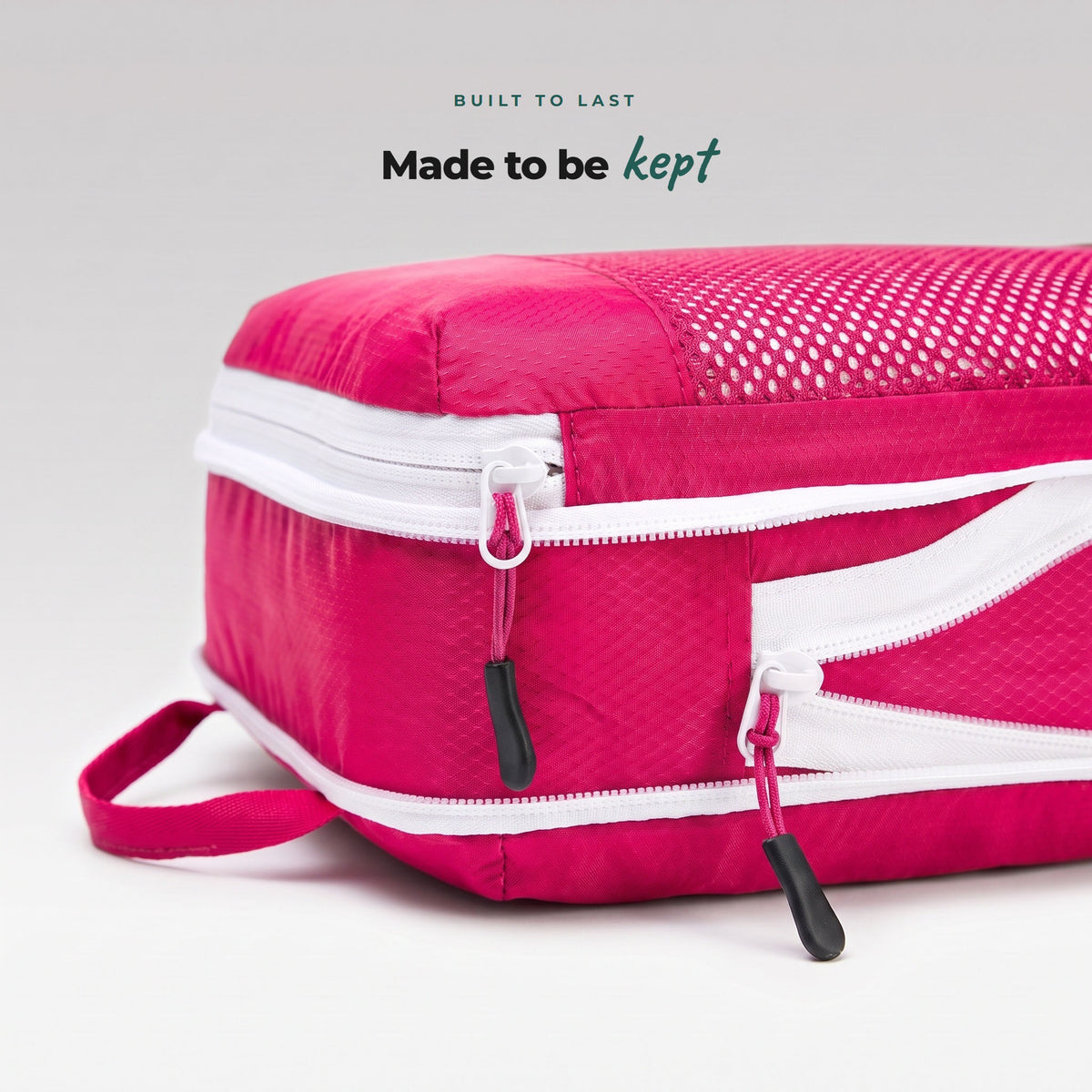 Close-up of Flamingo Pink Cube Packer packing cube zip and pull cord, durable ripstop fabric built to last