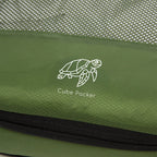 Close up of Cube Packer compression packing cube in green showing mesh fabric and logo detail