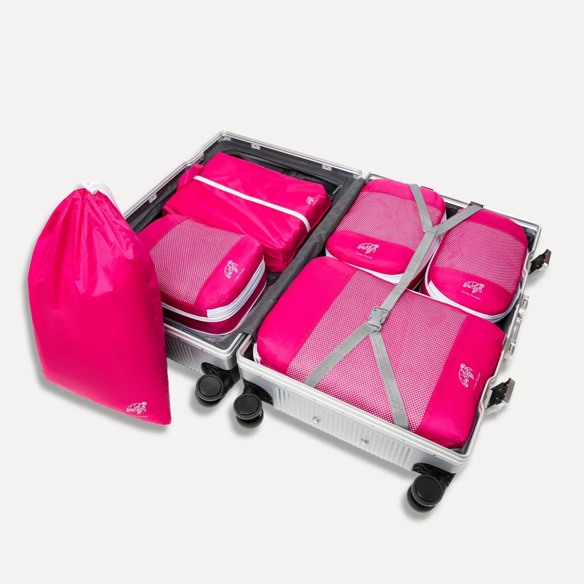 Open suitcase showing a 4-piece compression packing cube set with one small, two medium and one large cube organised inside
