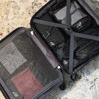 Open suitcase packed with Cube Packer compression packing cubes in black for organised for travel