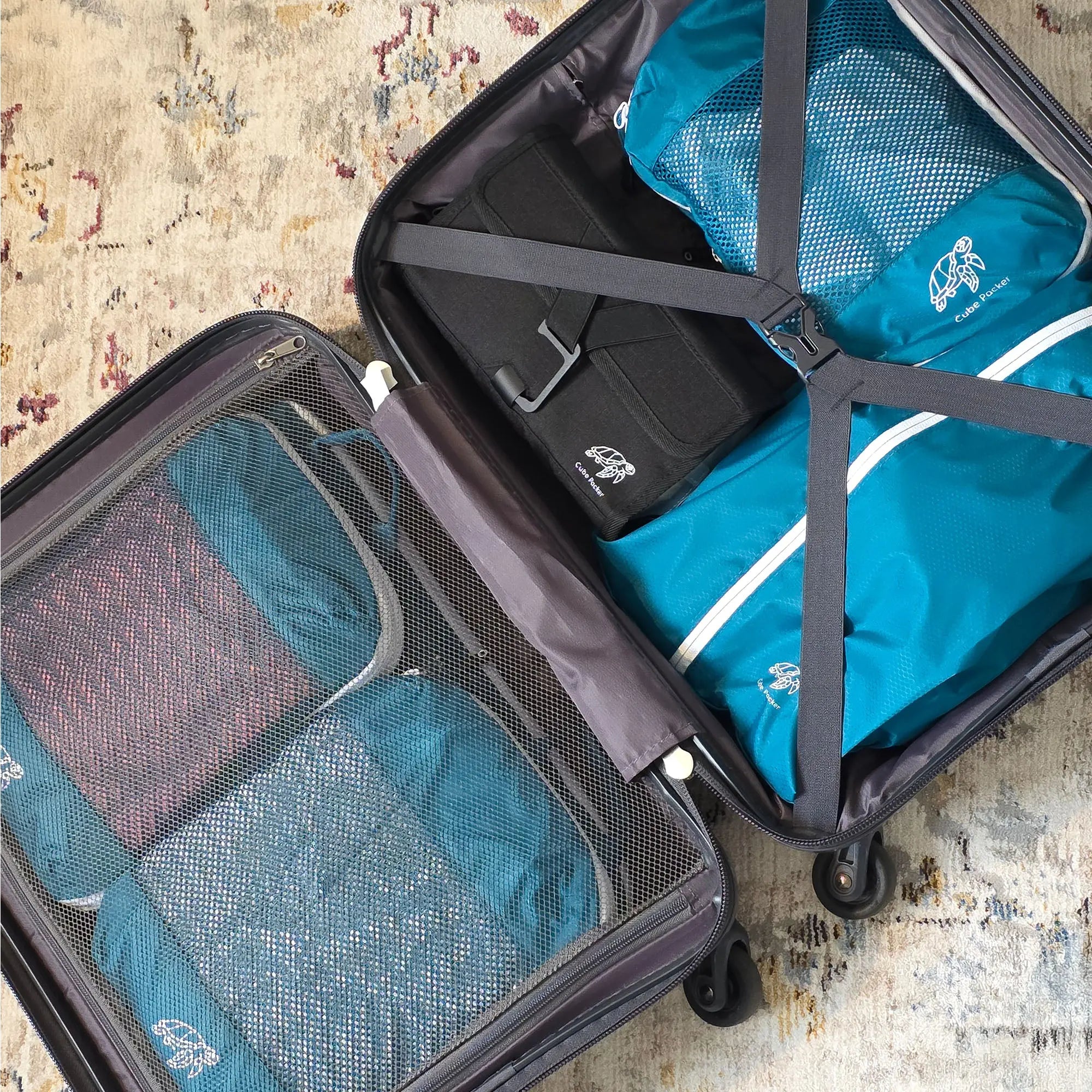 Open suitcase packed with Cube Packer compression packing cubes in teal for organised for travel