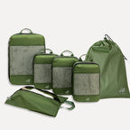 Cube Packer Essential Bundle with compression packing cubes, shoe bag and laundry bag in green on a white background