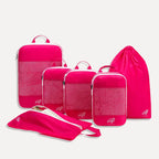 Cube Packer Essential Bundle with compression packing cubes, shoe bag and laundry bag in pink on a white background