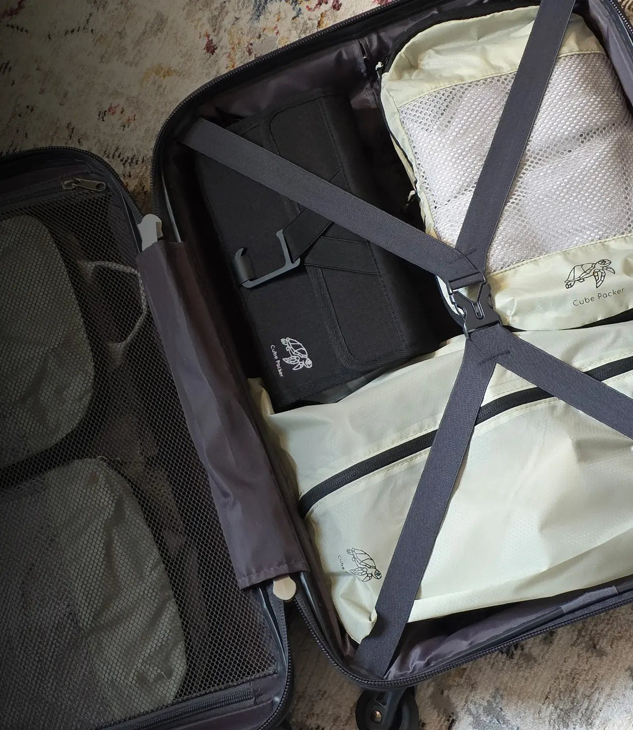 Open suitcase neatly packed with Cube Packer packing cubes and travel organisers