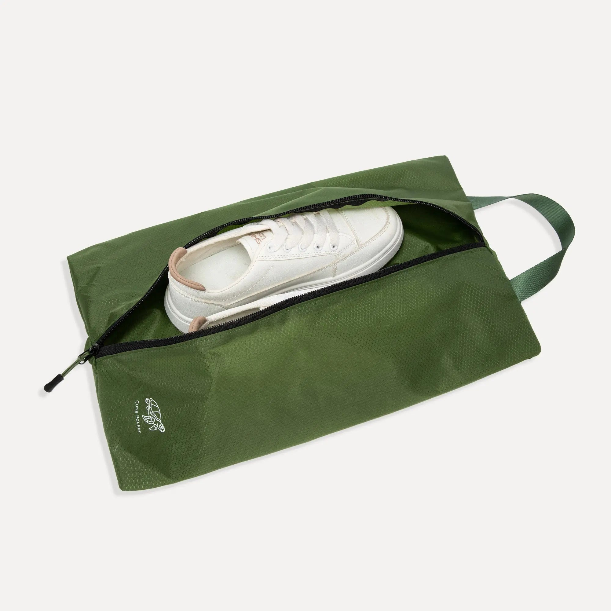 Open Cube Packer shoe bag in green showing interior space for travel footwear