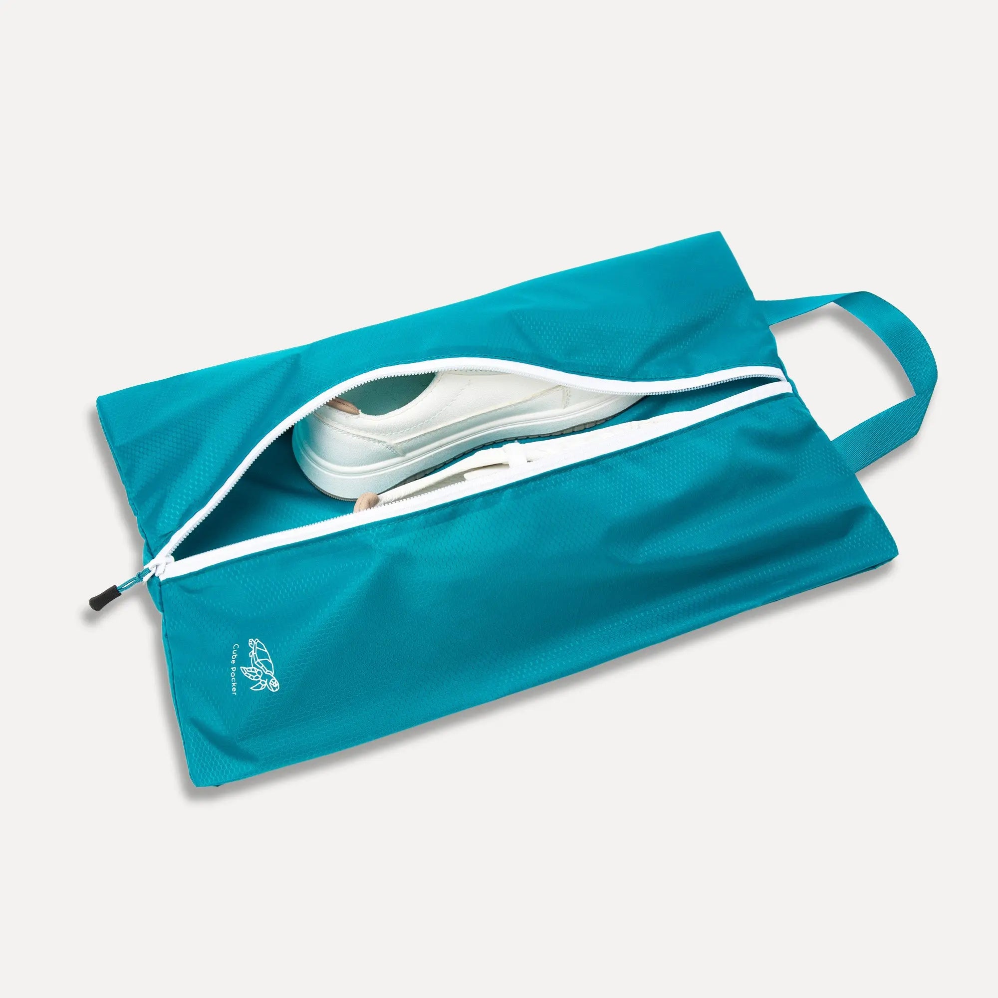 Open Cube Packer shoe bag in teal showing interior space for travel footwear