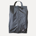 Cube Packer shoe bag in black standing upright for clean and organised travel storage