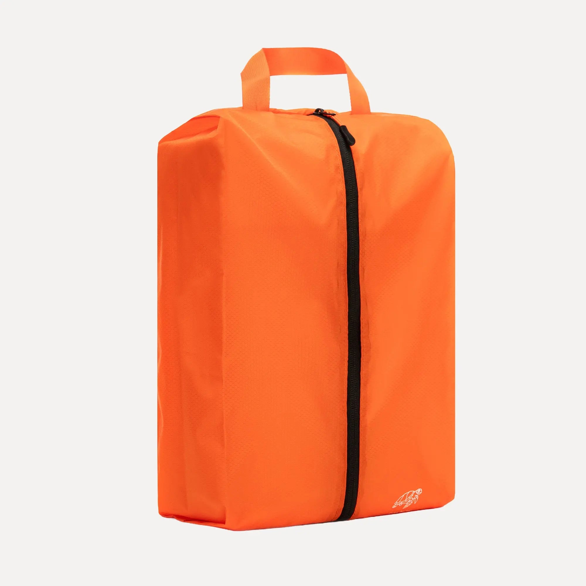 Cube Packer shoe bag in orange standing upright for clean and organised travel storage