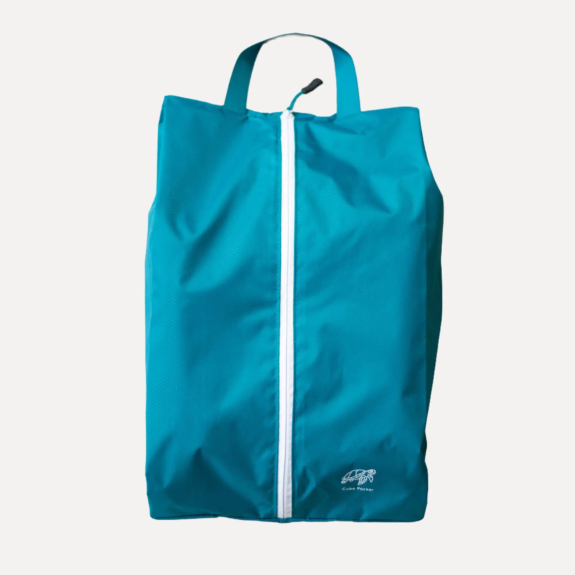 Cube Packer shoe bag in teal standing upright for clean and organised travel storage