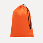 Cube Packer travel laundry bag in orange with drawstring closure for separating clothes while travelling