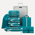 Cube Packer Travel System Bundle in Teal Blue including compression packing cubes, shoe bag, laundry bag and toiletries bag arranged in front of a suitcase
