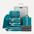 Cube Packer Travel System Bundle in Teal including compression packing cubes, shoe bag, laundry bag and toiletries bag arranged in front of a suitcase
