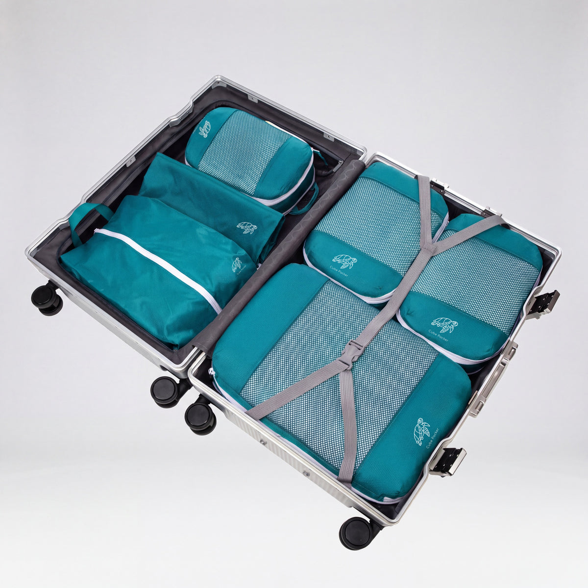 Reef Teal Cube Packer Essential Packing Bundle packed inside an open aluminium suitcase