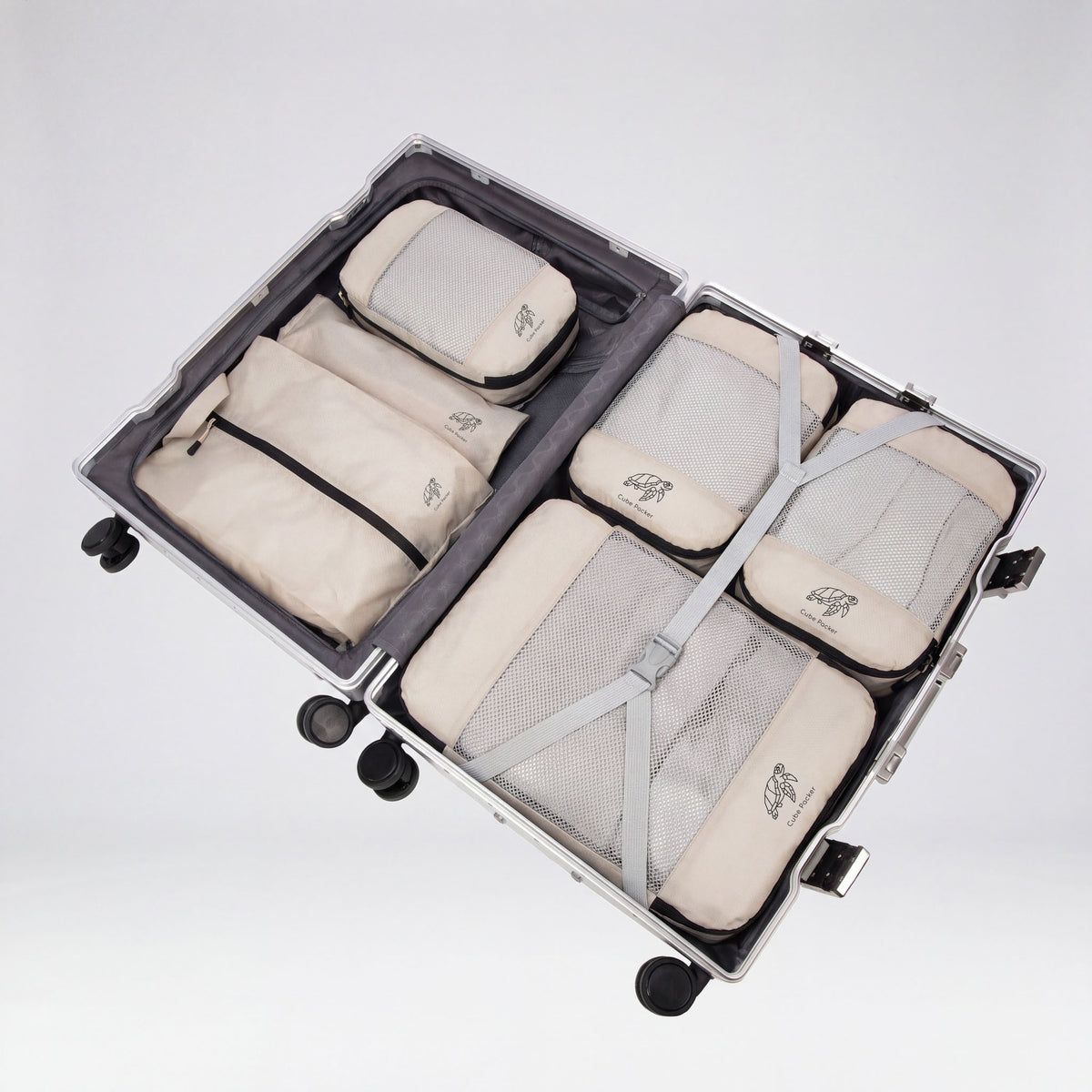 Sand Cube Packer Essential Packing Bundle packed inside an open aluminium suitcase
