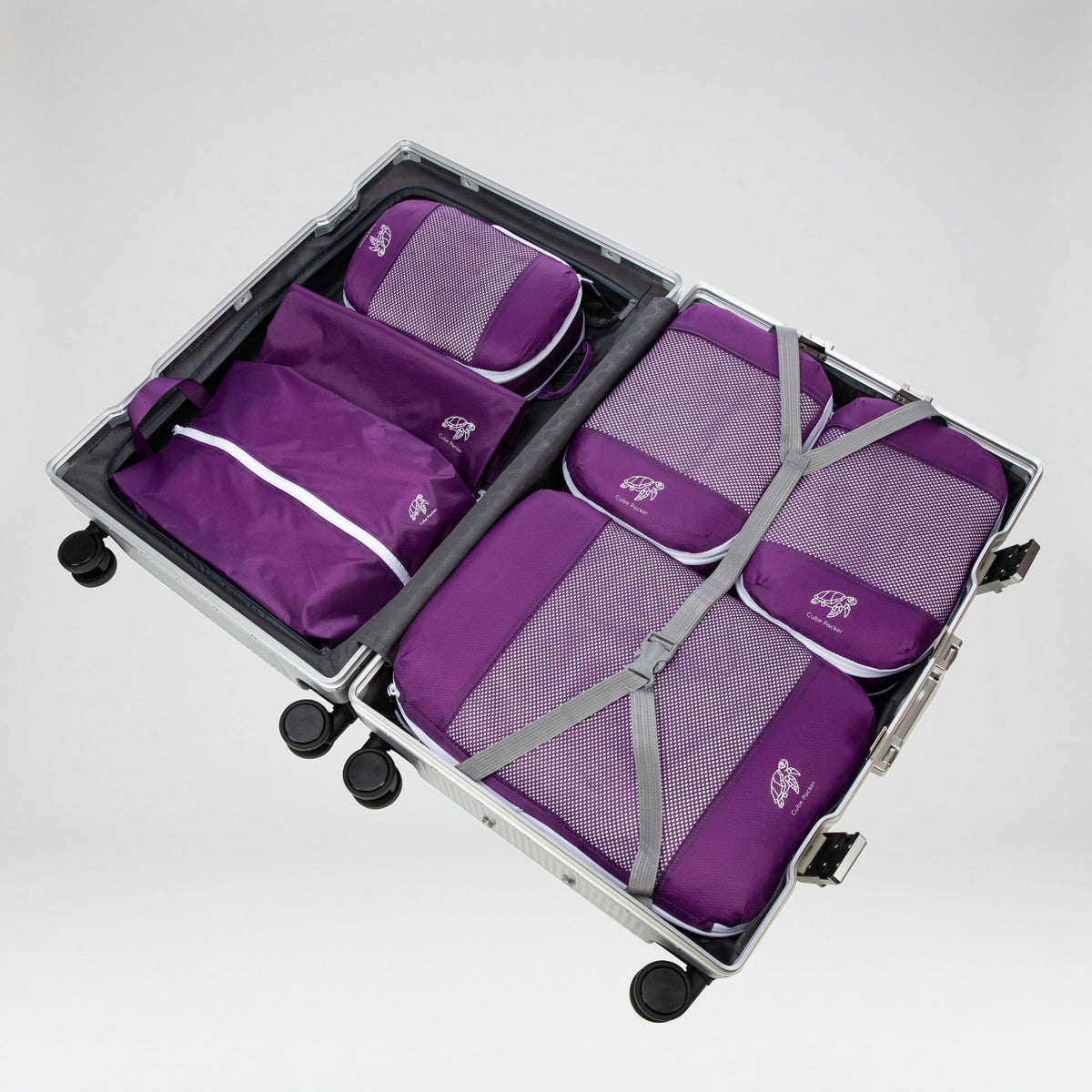 Violet Reef Cube Packer Essential Packing Bundle packed inside an open aluminium suitcase