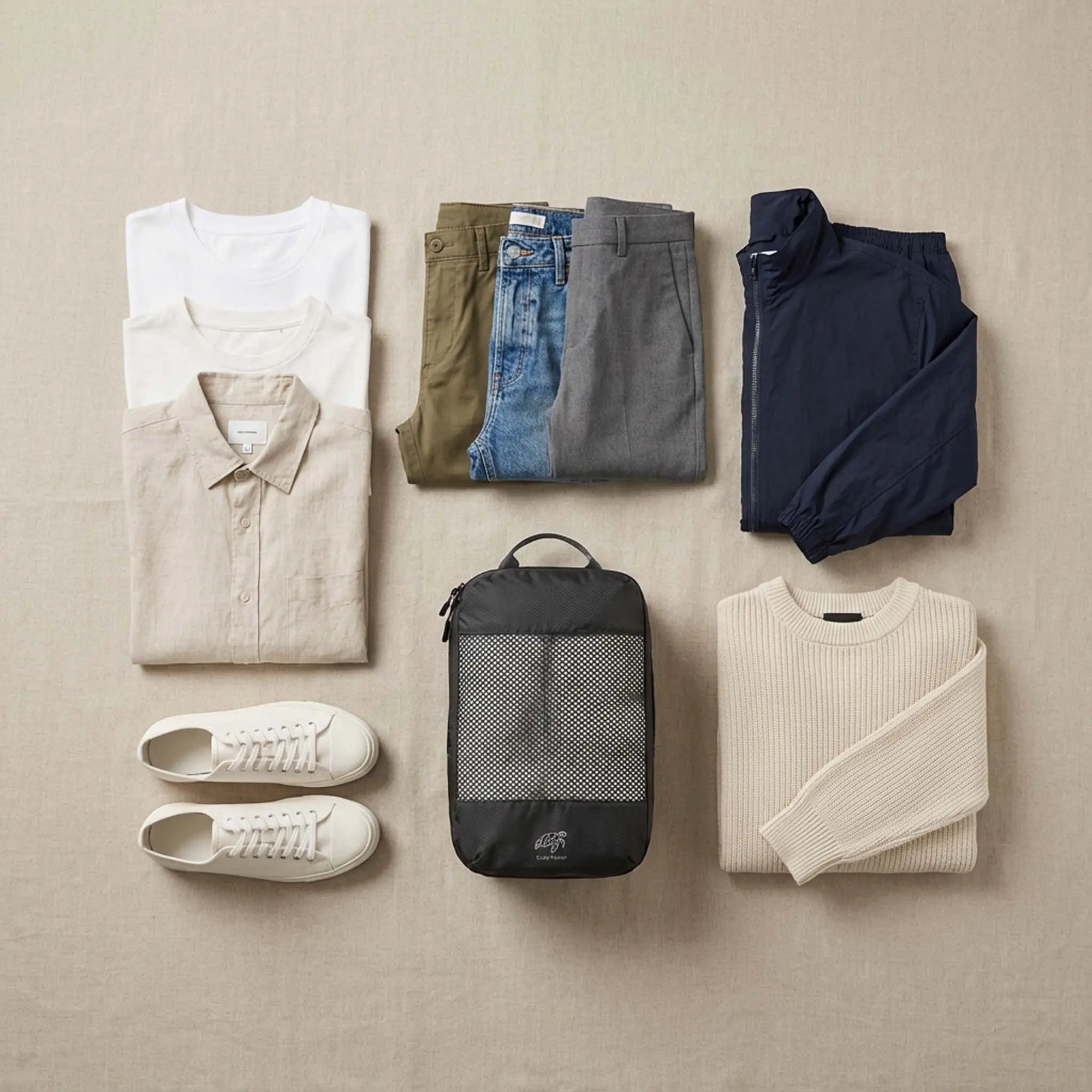 Clothing organised by category using packing cubes to follow travel packing rules